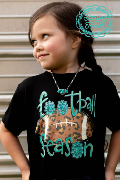 Who isn't ready for football season? We sure are! This graphic tee is perfect for a football loving gal! We have a cheetah print football, with turquoise conchos replacing the "o"s for a cute and fun design. MSRP: $25+